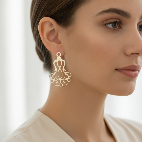 Filigree drop earring worn on model ear in soft natural light