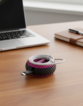 3D-printed cable winder on a tidy desk with charging cable